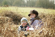 Siblings in a stack of dried leaves
