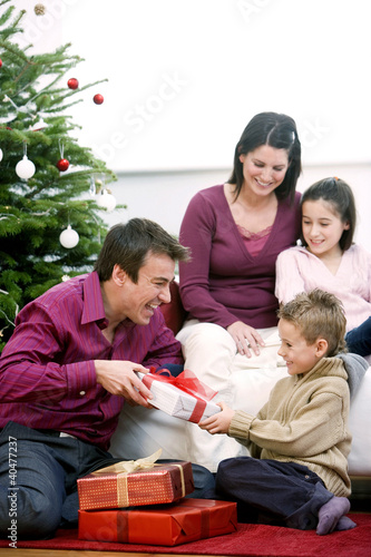 Photo: Family gathering around the Christmas tree Family gathering around the Christmas tree