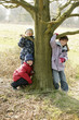 Children posing by a tree
