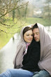 Loving couple wrapped in blanket