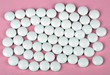 white pill on pink background