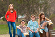 Happy teenage boys and girls spending time together