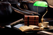 Electric green table lamp and books with armchair and cup