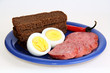 bread, sausage, eggs and red peppers on blue plate bread, sausage, eggs and red peppers on blue plate