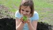 child with a plant outdoor