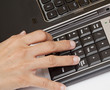 Typing on keyboard.