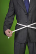 Businessman with measuring tape around his waist