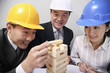 Business people playing wooden blocks game