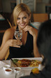 Woman holding a glass of water looking at her partner