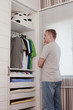 Man looking in wardrobe