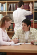 Man and woman having discussion in the library