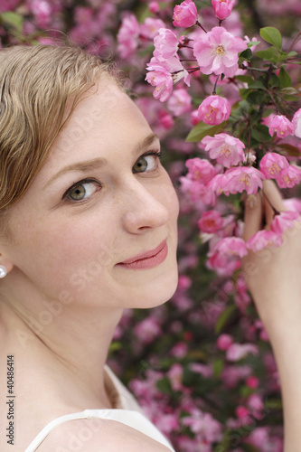Photo: Woman in wedding gown posing with flowers Woman in wedding gown posing with flowers