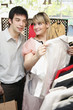 Man and woman choosing clothes in shop