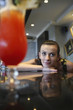 Woman resting her chin on bar counter