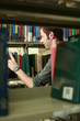 Man searching for a book in the library