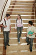 Two men and a woman walking down the stairs
