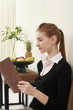 Woman in formal wear reading book