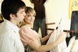 Man and woman choosing clothes in shop
