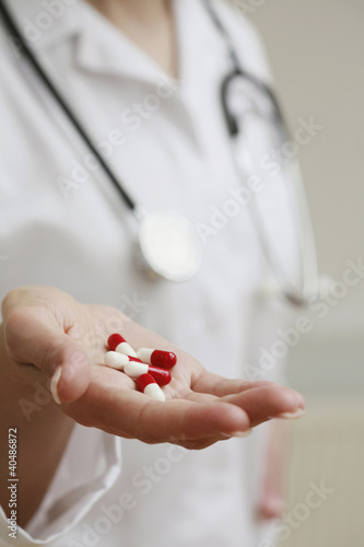 Photo: Woman holding capsules in hand Woman holding capsules in hand