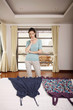 Woman looking at two blouses on bed