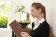 Woman in formal wear reading book