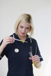 Woman holding test tube and pipette