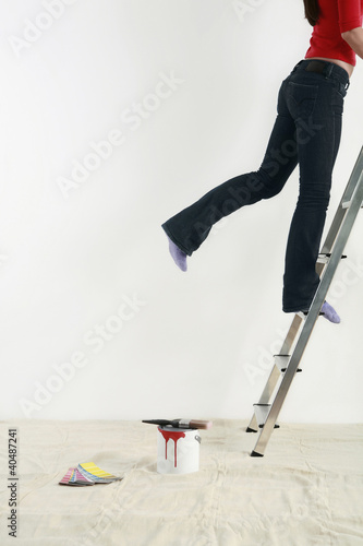 Photo: Woman climbing up ladder Woman climbing up ladder