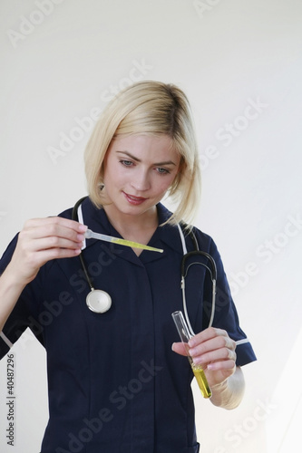 Photo: Woman holding test tube and pipette Woman holding test tube and pipette