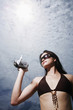 Woman in bikini using video camera