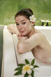 Woman in bathtub smiling at the camera