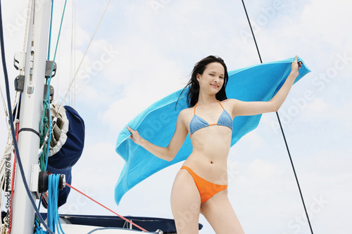 Photo: Woman in bikini holding a towel Woman in bikini holding a towel