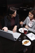 Businesswomen having discussion over dessert