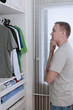 Man looking in wardrobe