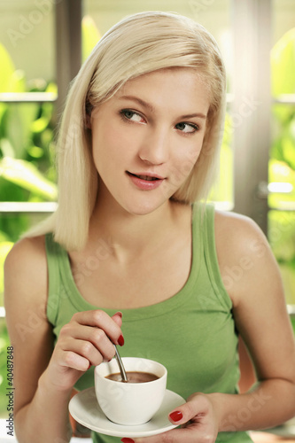 Photo: Woman enjoying a cup of coffee Woman enjoying a cup of coffee