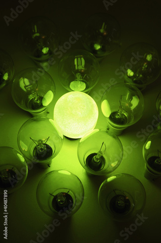 Photo: Green lightbulb among other lightbulbs Green lightbulb among other lightbulbs