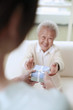 Woman giving senior woman a box of gift