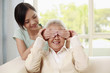 Photo: Woman covering senior woman's eyes Woman covering senior woman's eyes