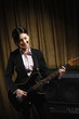 Young woman playing electric guitar