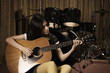Young woman playing guitar