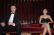 Man and woman sitting on couch