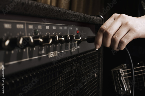 Photo: Plugging cable into amplifier Plugging cable into amplifier