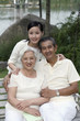 Foto: Woman posing with senior couple Woman posing with senior couple
