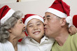 Foto: Senior man and senior woman kissing boy Senior man and senior woman kissing boy