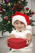 Foto: Boy holding heart shaped gift box Boy holding heart shaped gift box