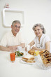 Senior man and senior woman having breakfast together