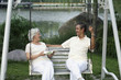 Foto: Senior couple chatting while sitting on a swing Senior couple chatting while sitting on a swing