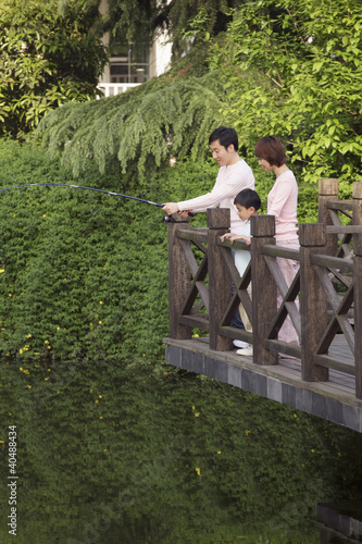 Photo: Man fishing, woman and boy watching Man fishing, woman and boy watching
