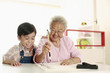Foto: Boy observing senior woman writing calligraphy Boy observing senior woman writing calligraphy