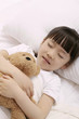 Girl sleeping and hugging soft toy