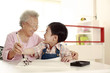 Foto: Senior woman teaching boy calligraphy Senior woman teaching boy calligraphy